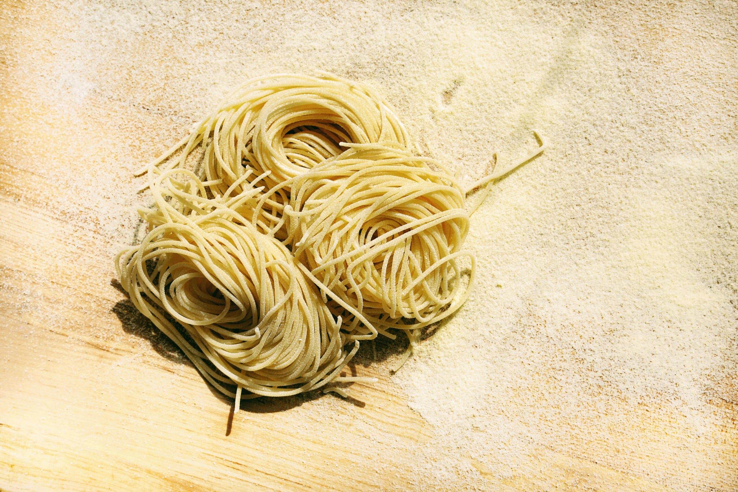 a pile of spaghetti sitting on top of a wooden table